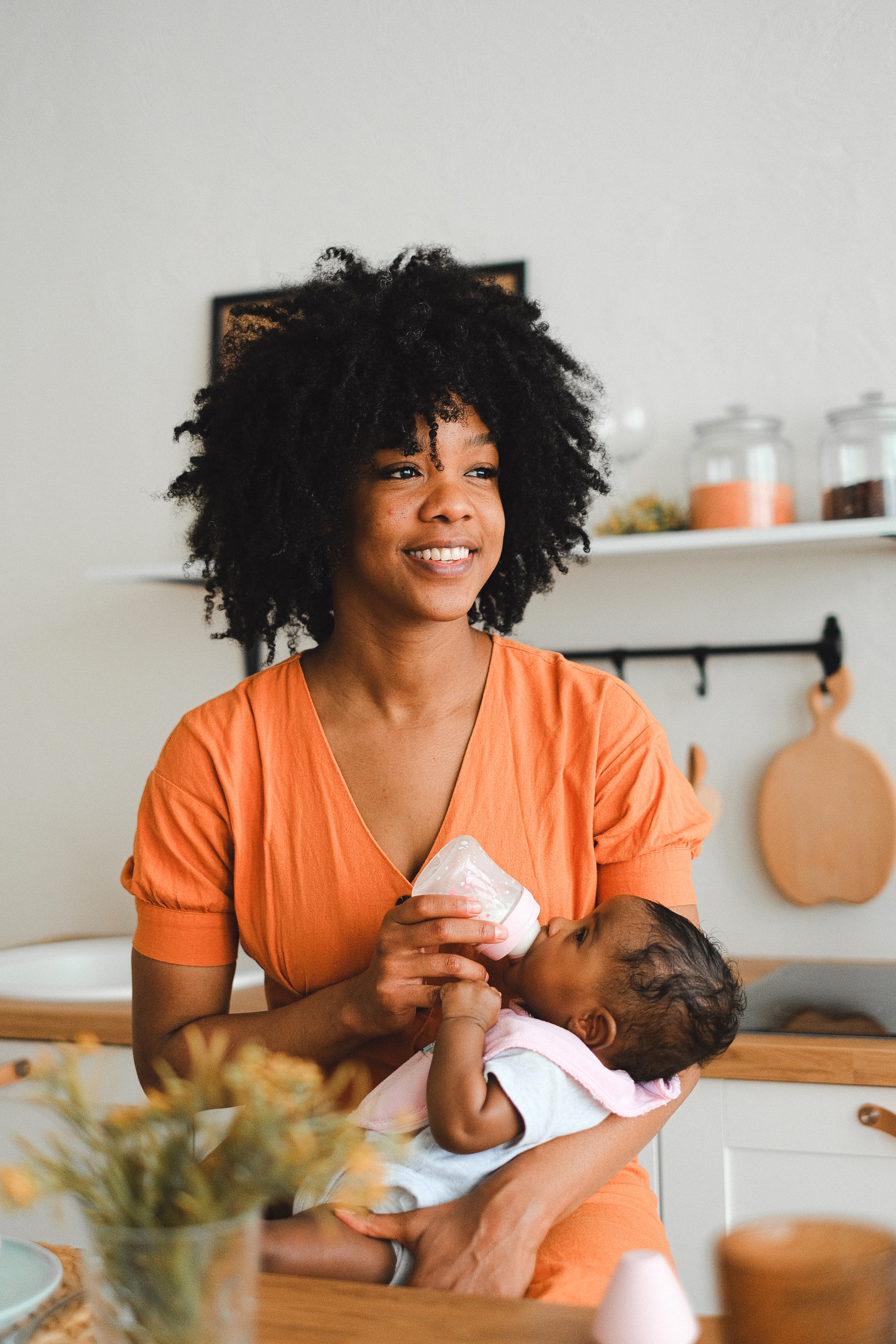 A woman holding a baby in her arms.