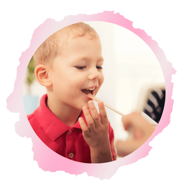 A child brushing his teeth with a pink brush.