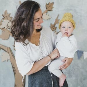 A woman holding a baby in her arms.