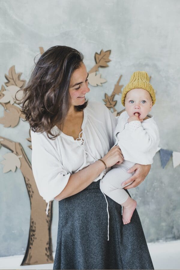 A woman holding a baby in her arms.